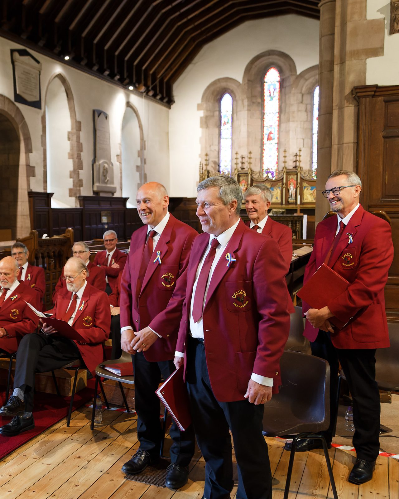 Choir members smiling during a concert