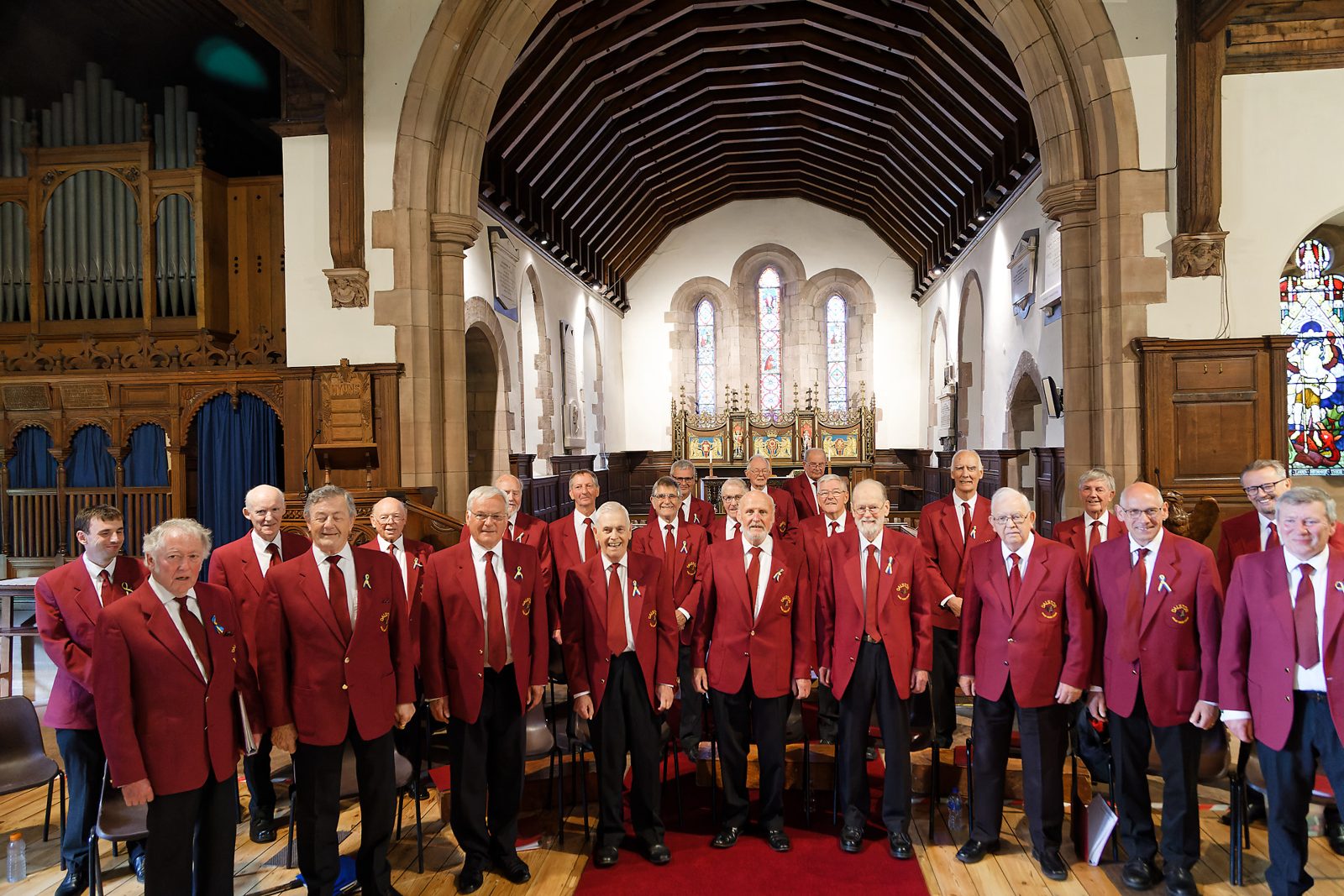 Dalston Male Voice Choir in their red blazers at St Michael's Church, Dalston
